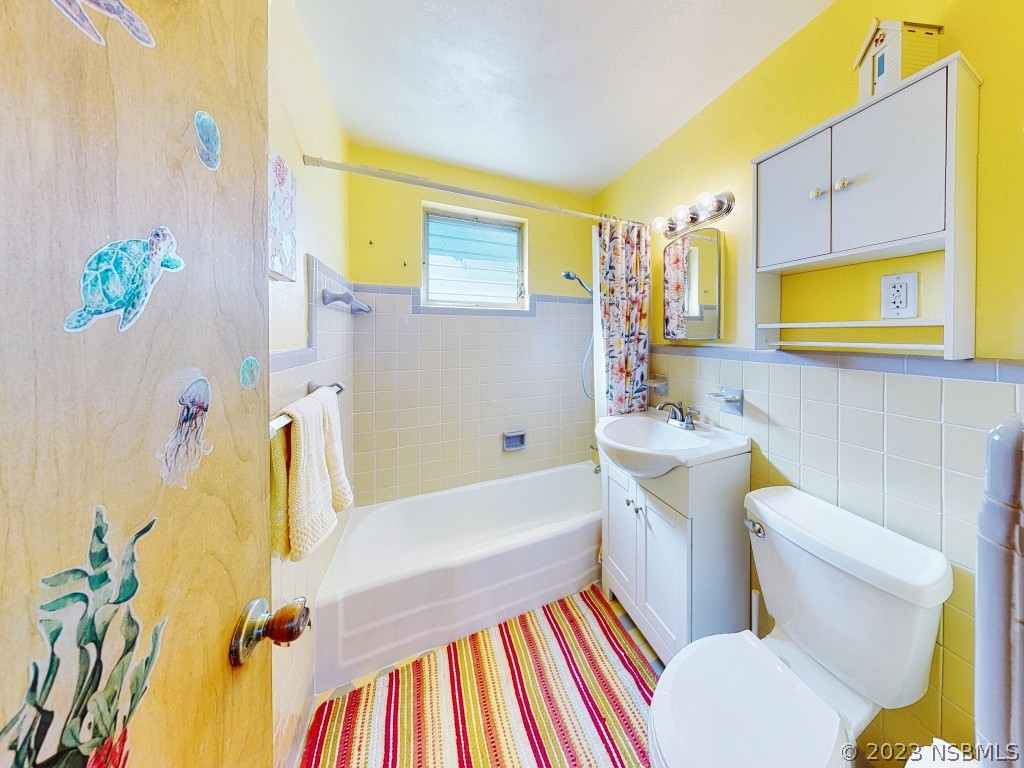 37 Ocean Shore Drive Ormond Beach, FL 32176 - Photo 26 of 50 a bathroom with a sink mirror vanity and toilet