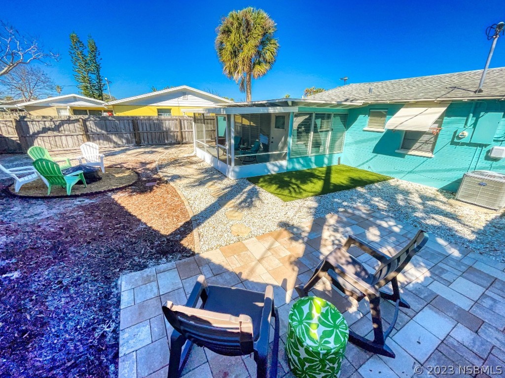 37 Ocean Shore Drive Ormond Beach, FL 32176 - Photo 40 of 50 a view of a patio with table and chairs under an umbrella