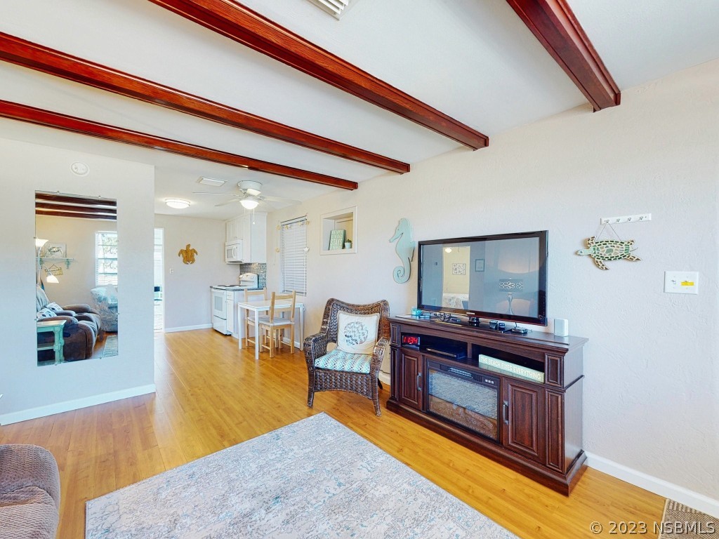 37 Ocean Shore Drive Ormond Beach, FL 32176 - Photo 6 of 50 a living room with furniture and a flat screen tv