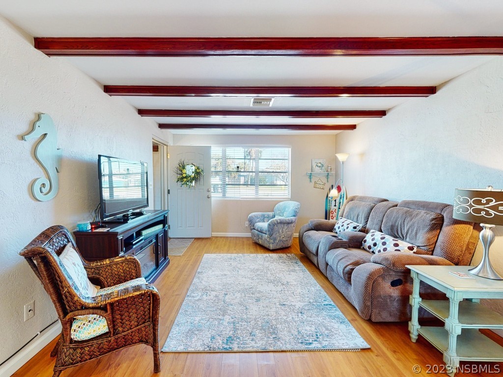 37 Ocean Shore Drive Ormond Beach, FL 32176 - Photo 9 of 50 a living room with furniture and a potted plant