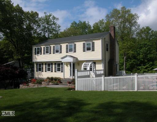 205 Westport Road Wilton, CT 06897 - Photo 1 of 1 a front view of a house with a garden