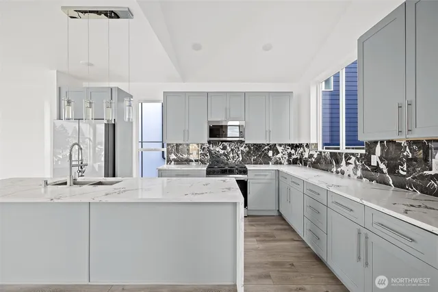 a kitchen with stainless steel appliances sink refrigerator and microwave