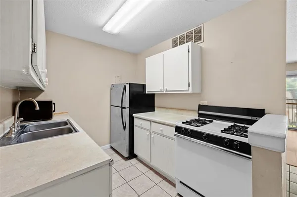 a kitchen that has a sink and a stove