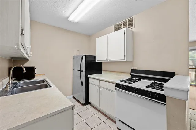 a kitchen that has a sink and a stove