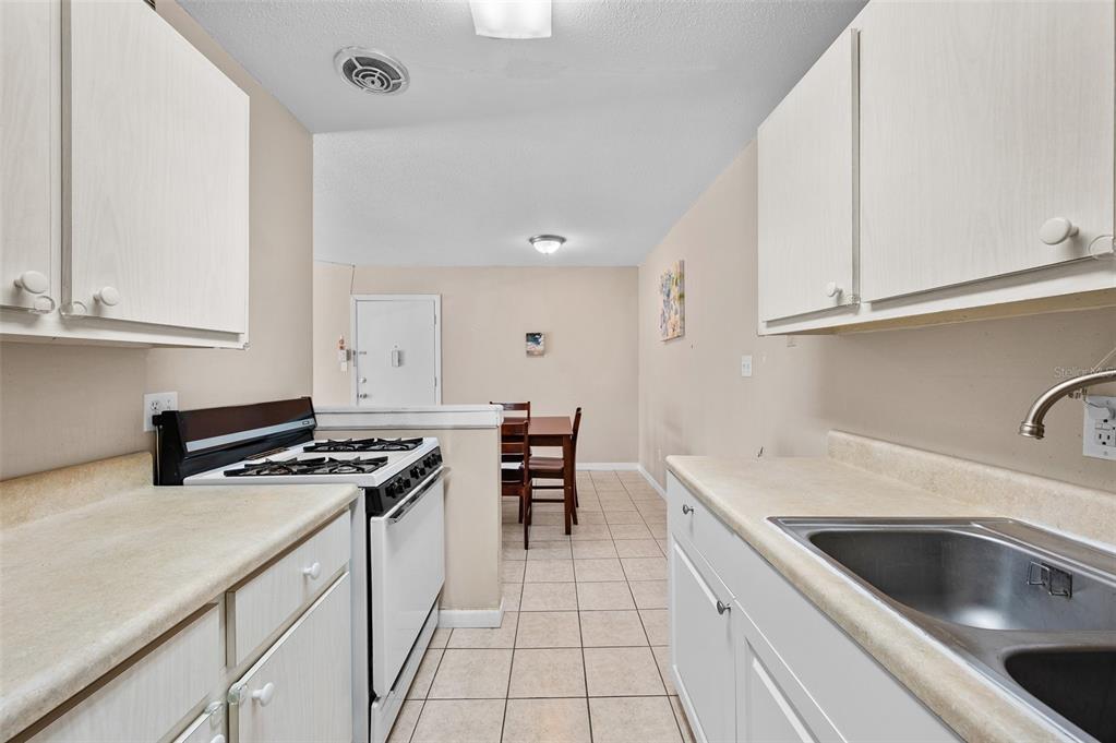 1700 Southwest 16th Court, Unit D24 Gainesville, FL 32608 - Photo 13 of 25 a kitchen that has a sink and a stove