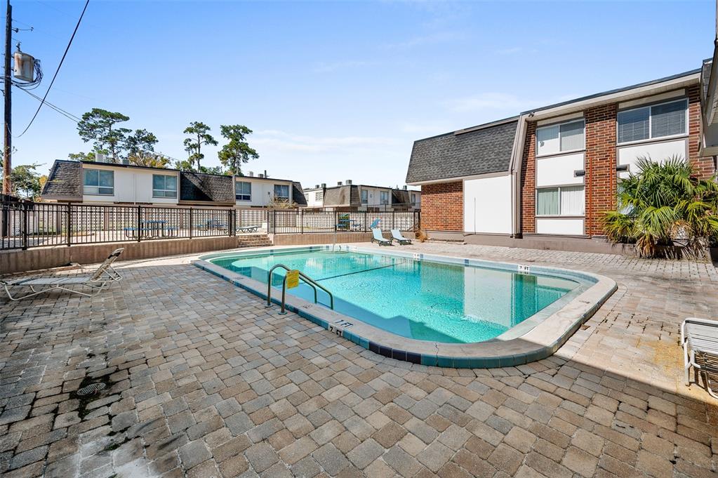 1700 Southwest 16th Court, Unit D24 Gainesville, FL 32608 - Photo 22 of 25 a view of a house with a swimming pool and sitting area