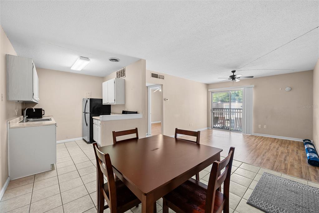 1700 Southwest 16th Court, Unit D24 Gainesville, FL 32608 - Photo 10 of 25 a view of a dining room with furniture and wooden floor
