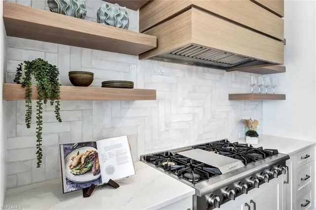 a view of kitchen island a sink wooden floor and living room view