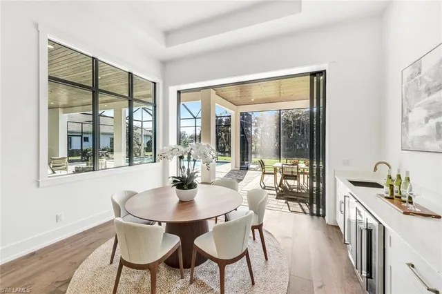 a dining room with furniture and wooden floor