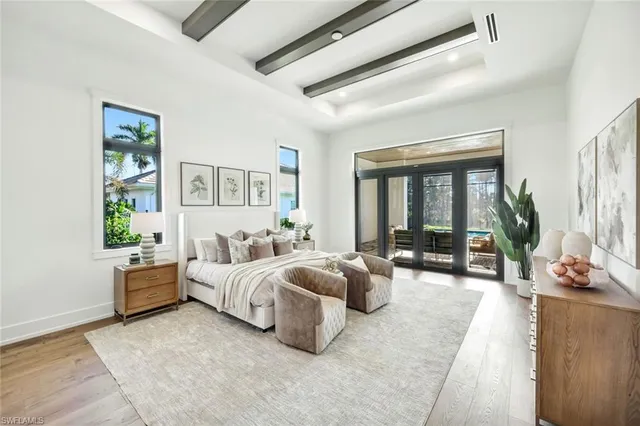 a bedroom with furniture and a large window