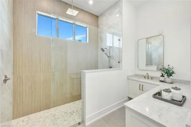 a bathroom with a double vanity sink mirror and shower