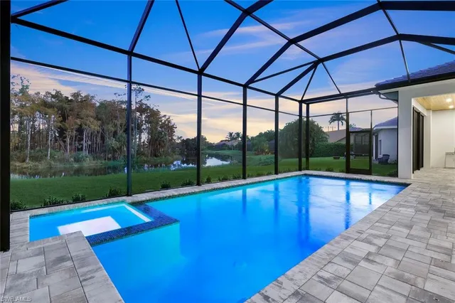 a view of yard with a table and chairs under an umbrella