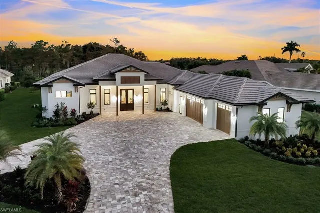 an aerial view of a house with garden space and ocean view