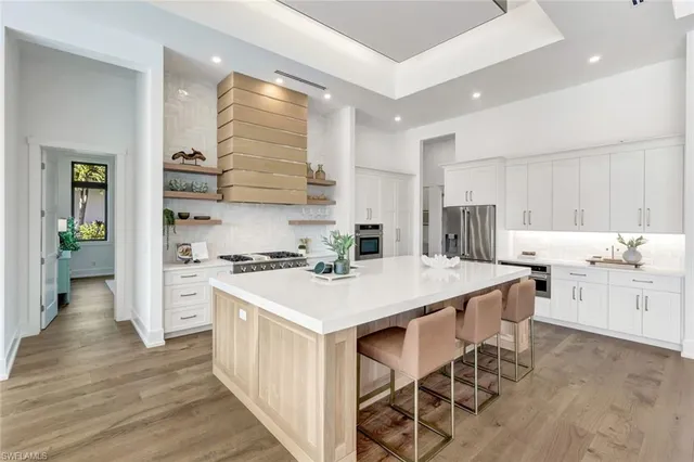 a kitchen with a white cabinets and chairs