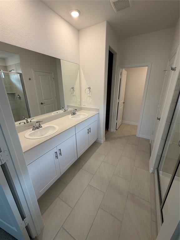 2203 Rannoch Street Sherman, TX 75092 - Photo 7 of 13 a spacious bathroom with a double vanity sink and mirror