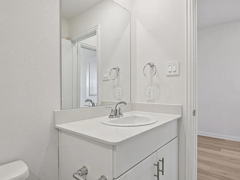 2203 Rannoch Street Sherman, TX 75092 - Photo 10 of 13 a bathroom with a sink and a mirror