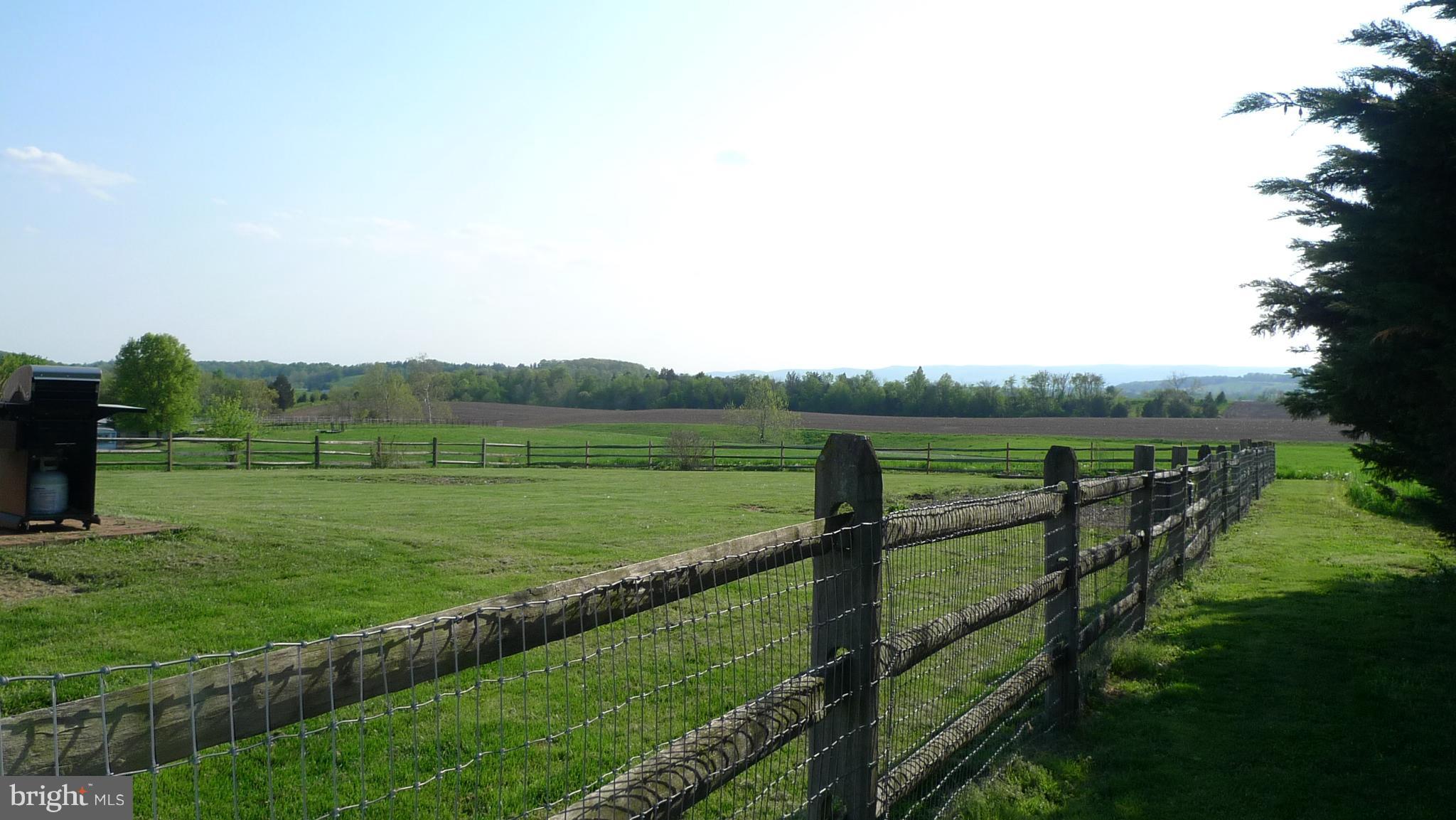 11428 Hill Road Keymar, MD 21757 - Photo 2 of 30 a view of a green field with wooden fence