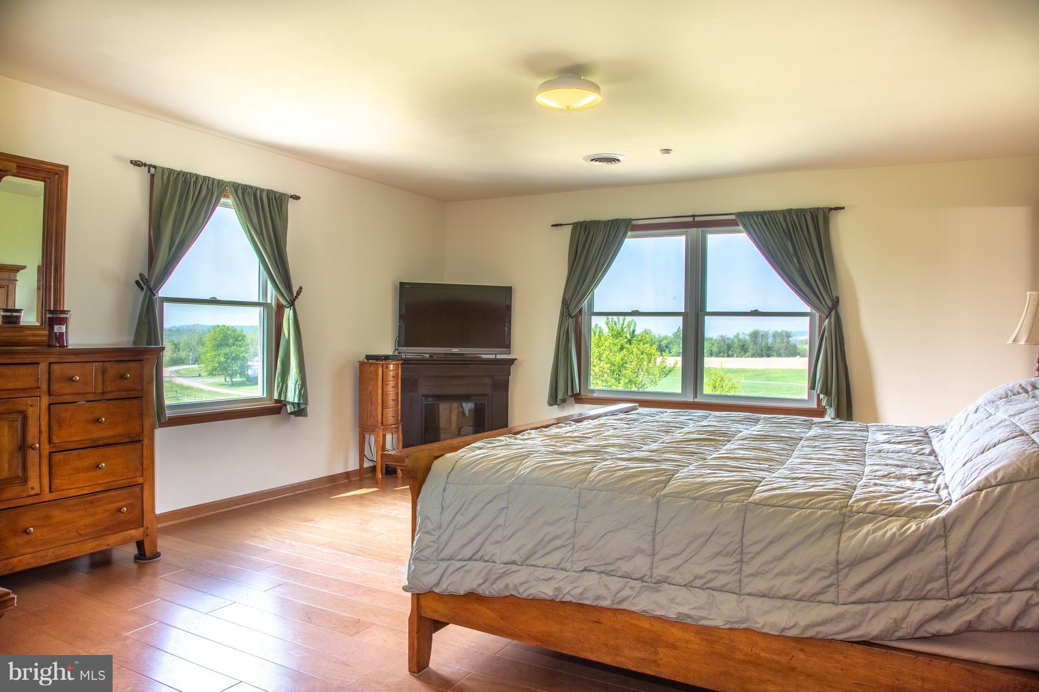 11428 Hill Road Keymar, MD 21757 - Photo 10 of 30 a bedroom with a bed and a television