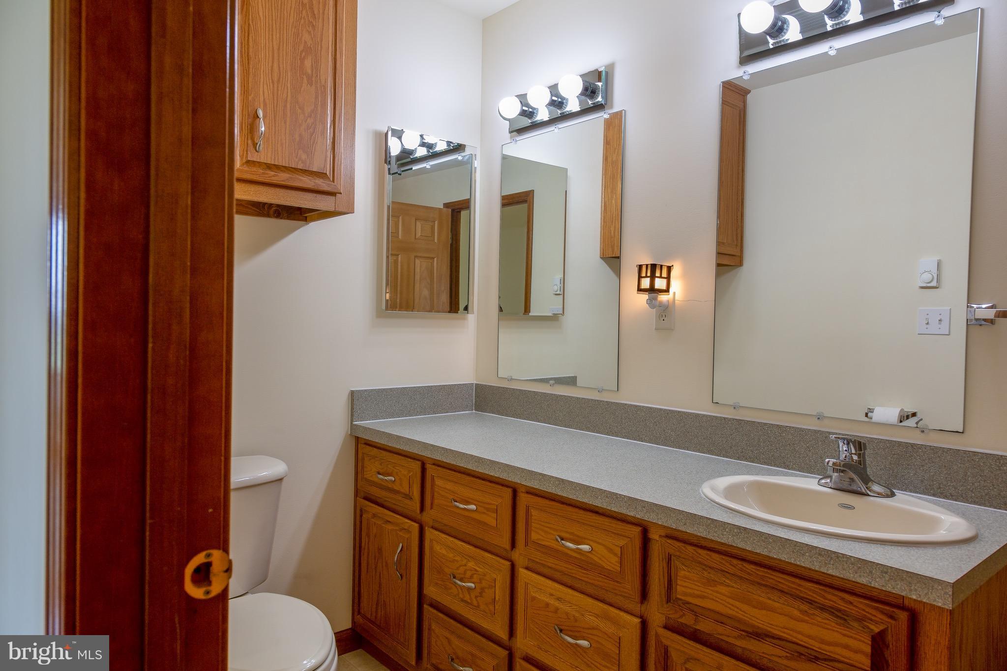 11428 Hill Road Keymar, MD 21757 - Photo 16 of 30 a bathroom with a granite countertop sink toilet and mirror