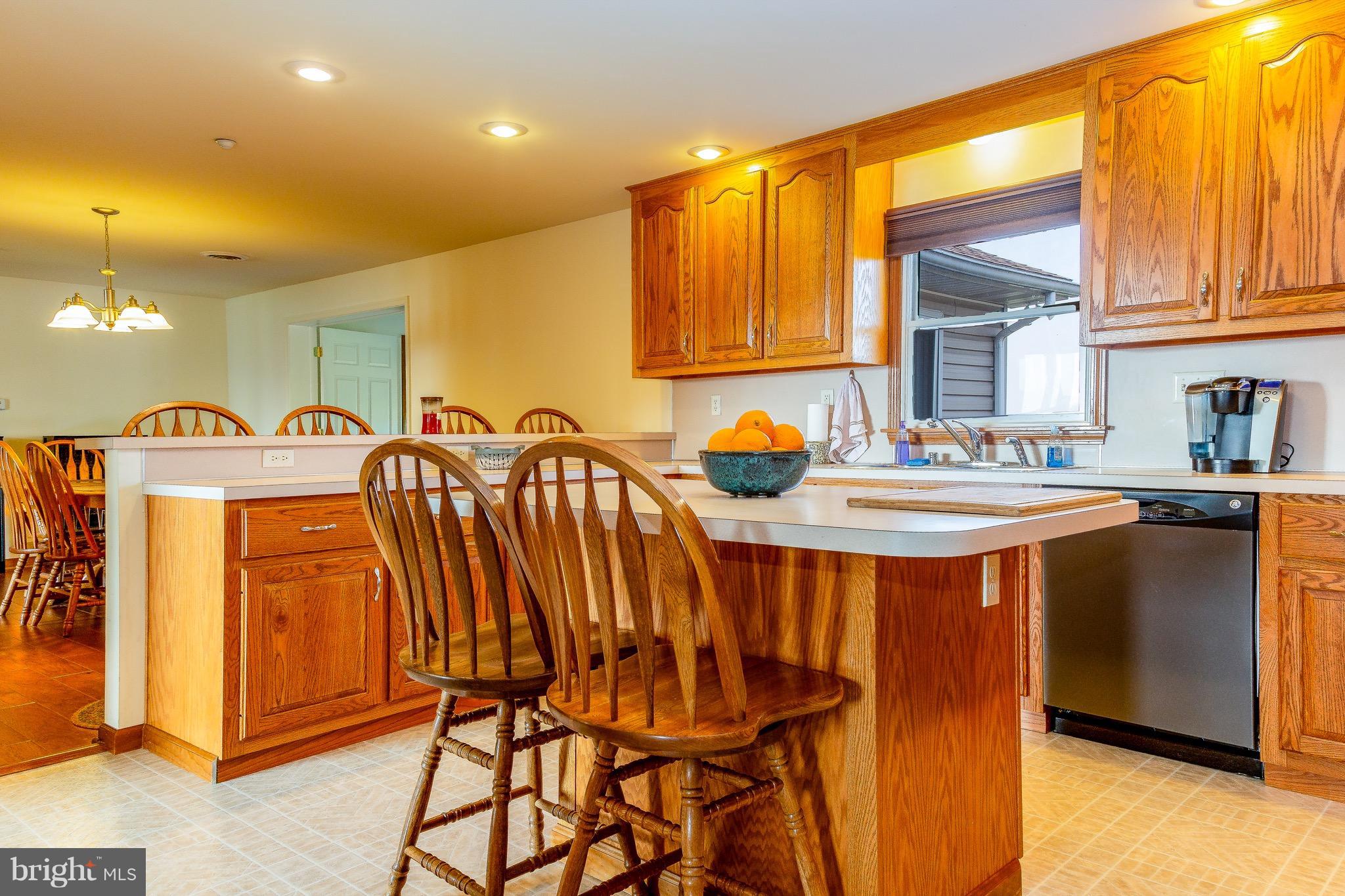 11428 Hill Road Keymar, MD 21757 - Photo 5 of 30 a dining room filled with stainless steel appliances granite countertop a refrigerator a sink a dining table and chairs with wooden floor