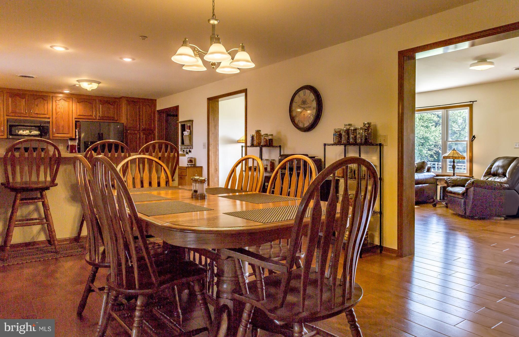 11428 Hill Road Keymar, MD 21757 - Photo 30 of 30 a dining room with furniture a chandelier and wooden floor