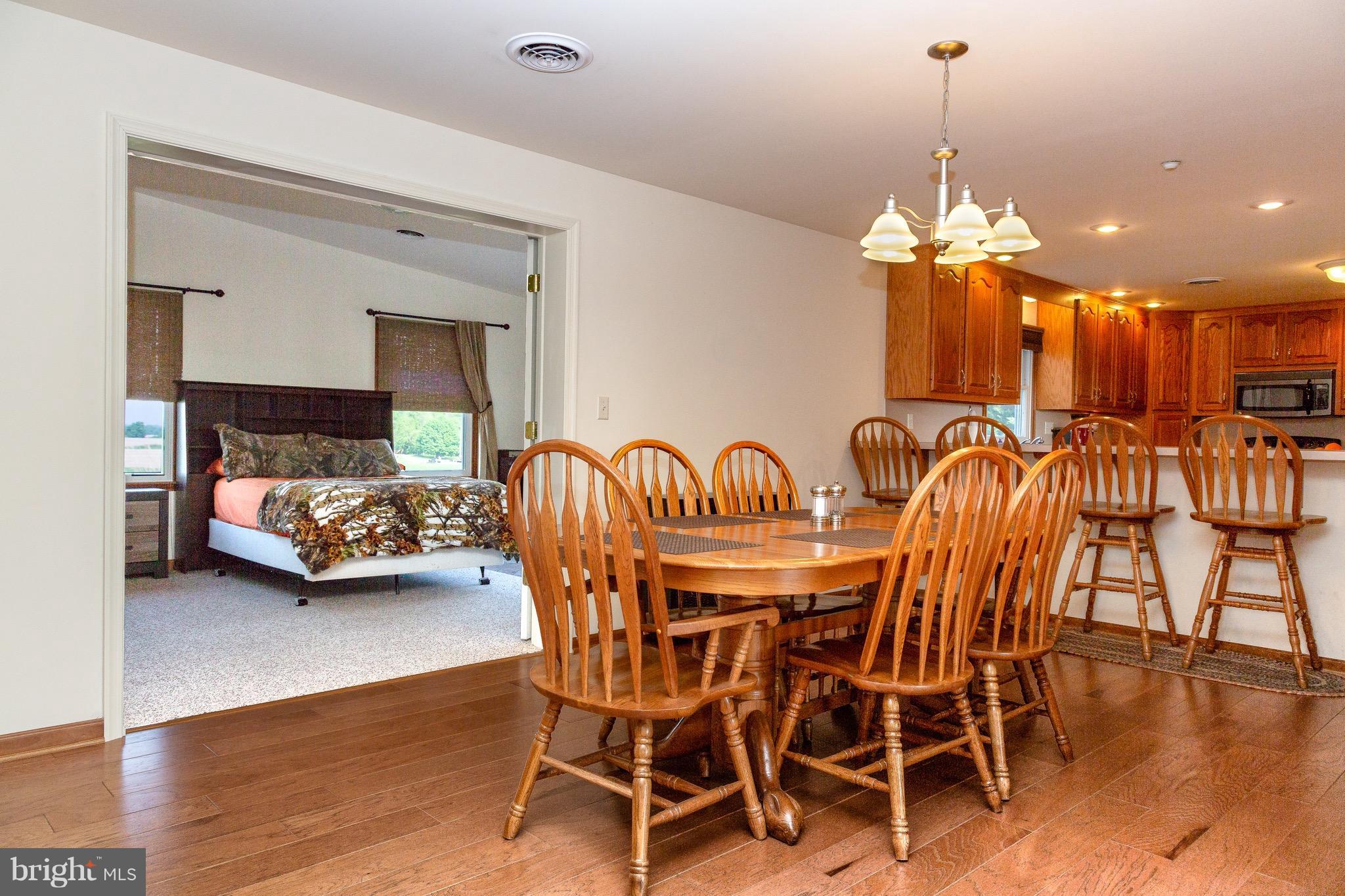 11428 Hill Road Keymar, MD 21757 - Photo 6 of 30 a view of a dining room with furniture wooden floor and chandelier
