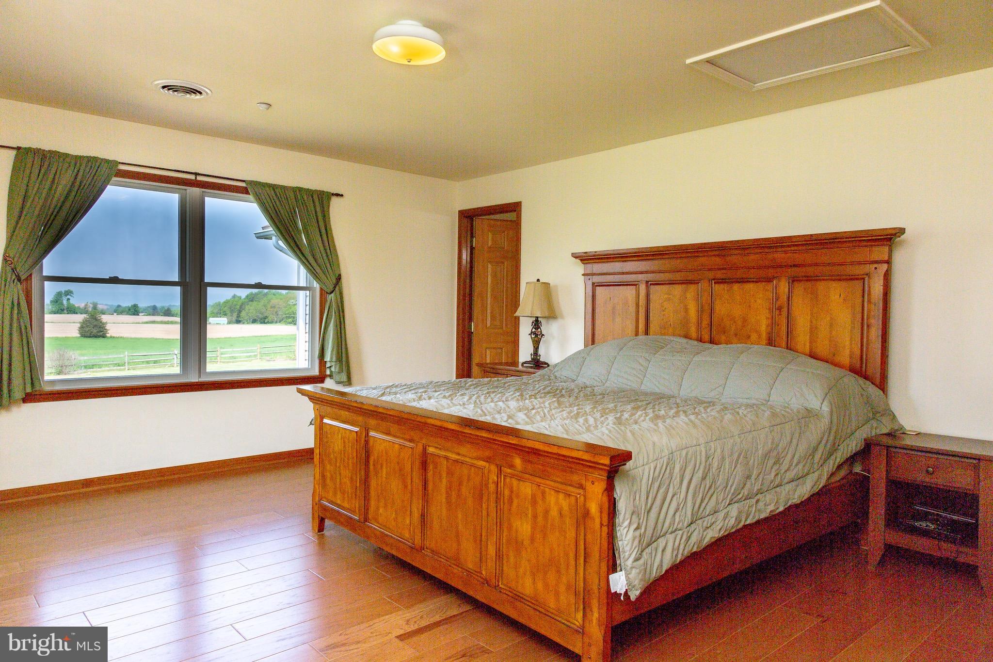 11428 Hill Road Keymar, MD 21757 - Photo 9 of 30 a bedroom with a large bed and a large window
