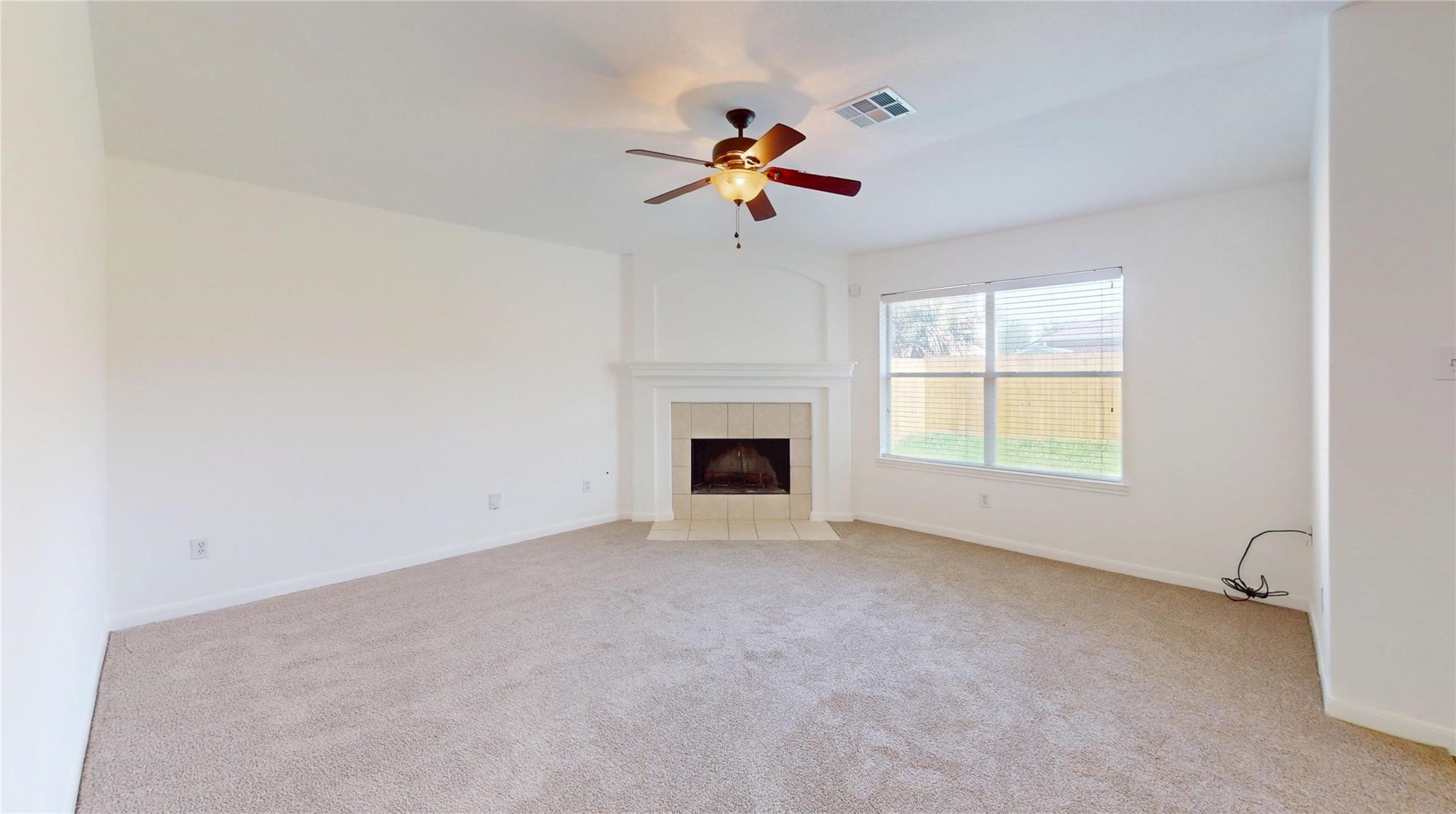20226 Sunset Ranch Drive Katy, TX 77449 - Photo 3 of 27 an empty room with chandelier fan and windows