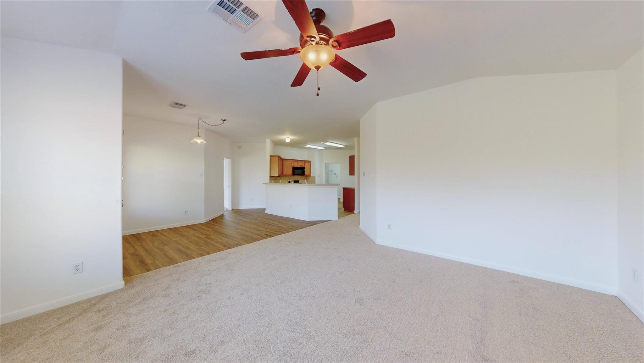 20226 Sunset Ranch Drive Katy, TX 77449 - Photo 4 of 27 an empty room with chandelier fan and windows