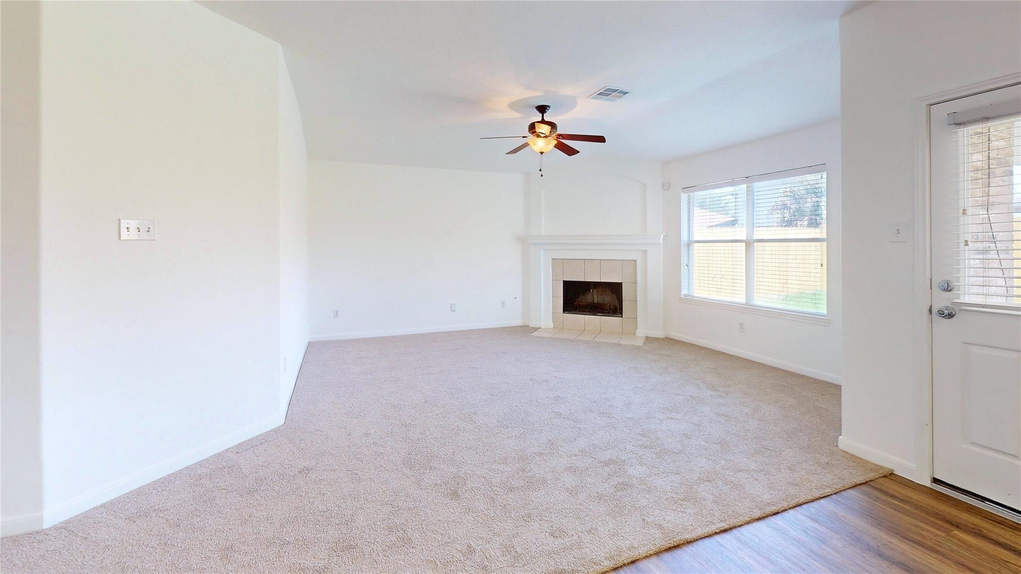 20226 Sunset Ranch Drive Katy, TX 77449 - Photo 5 of 27 an empty room with windows and fireplace