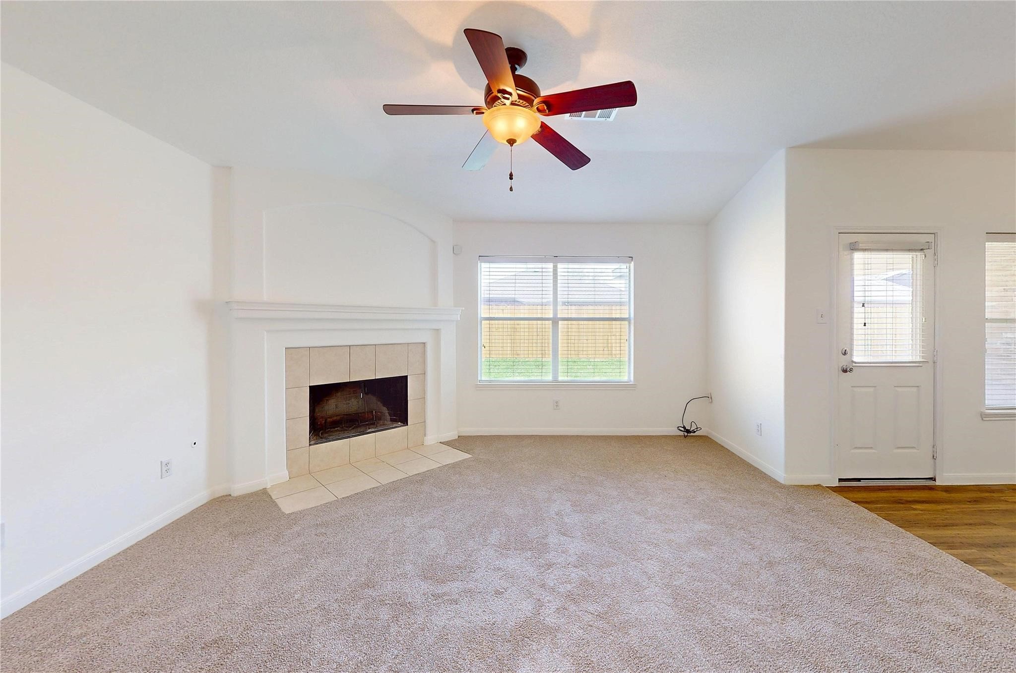 20226 Sunset Ranch Drive Katy, TX 77449 - Photo 6 of 27 an empty room with chandelier fan and windows