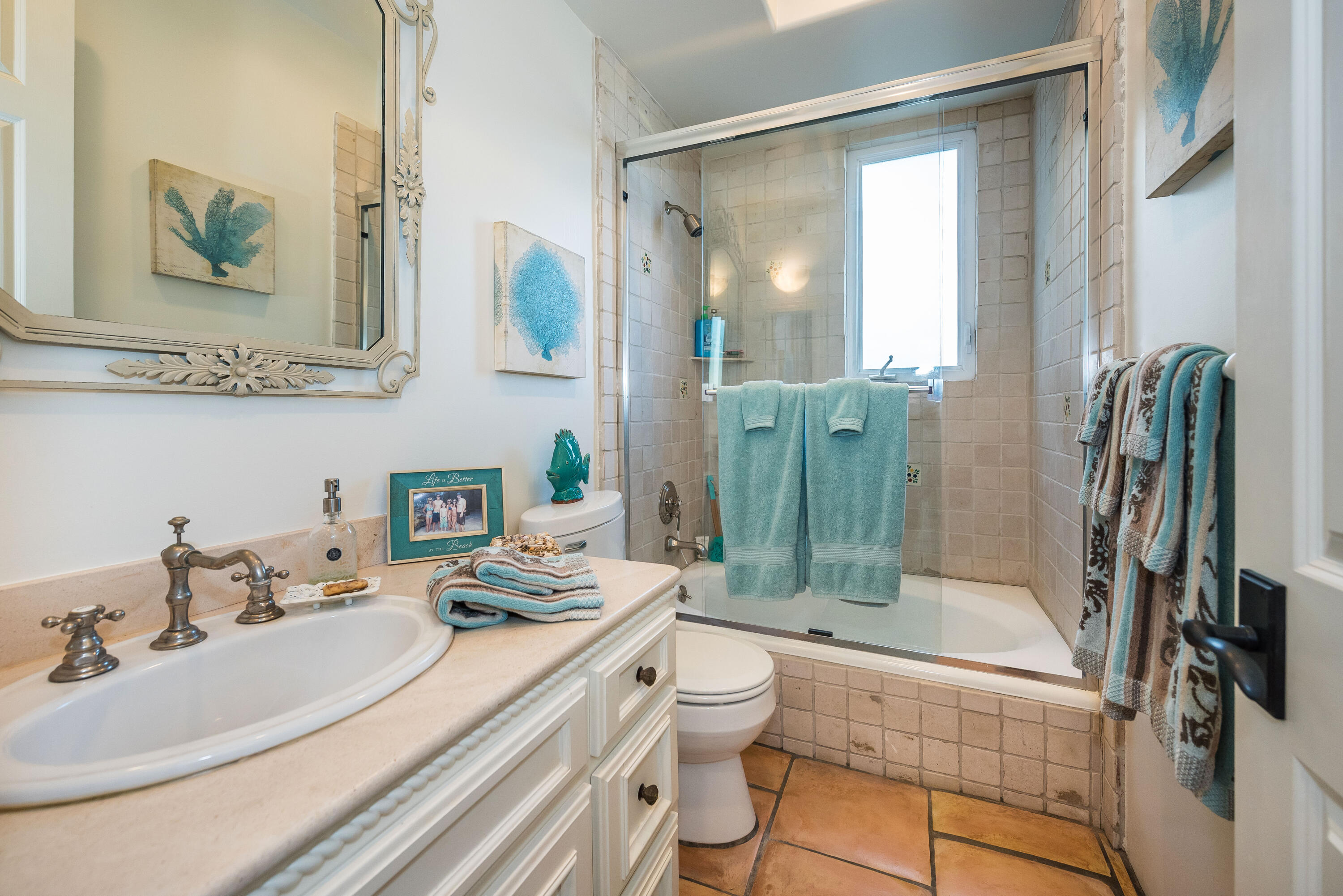 875 Sand Point Road Carpinteria, CA 93013 - Photo 16 of 25 a bathroom with a granite countertop sink a toilet a mirror and shower