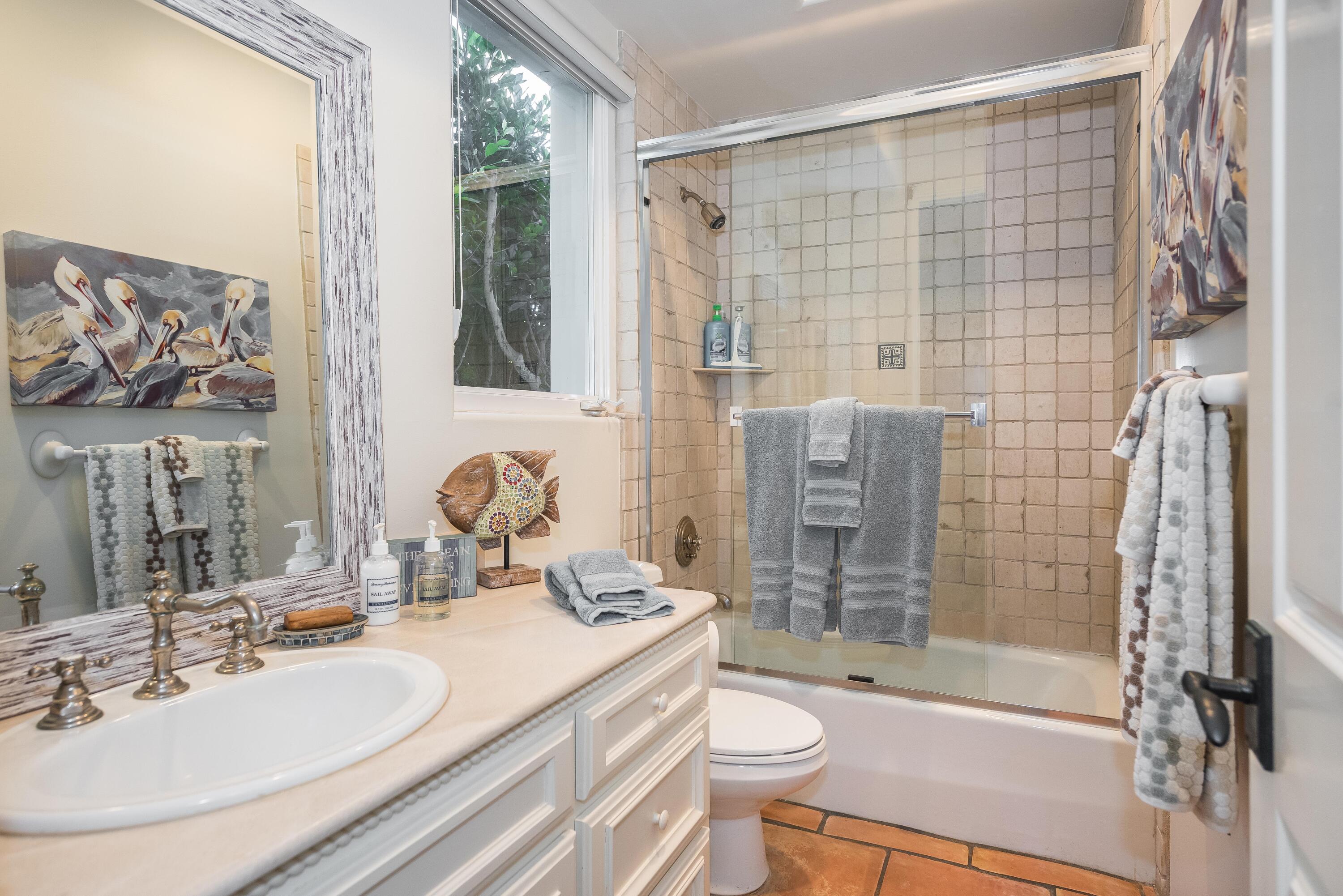 875 Sand Point Road Carpinteria, CA 93013 - Photo 18 of 25 a bathroom with a bathtub shower sink vanity mirror and toilet