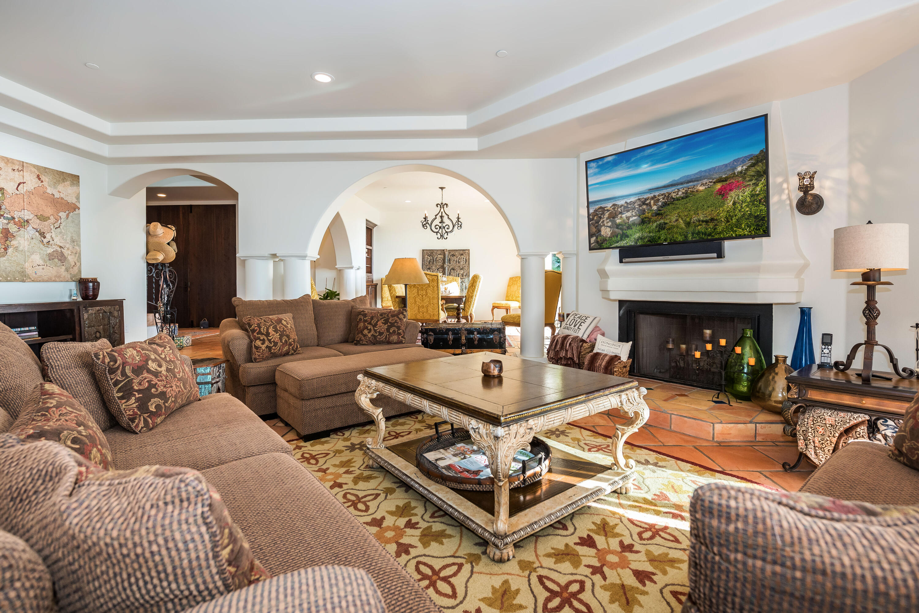 875 Sand Point Road Carpinteria, CA 93013 - Photo 4 of 25 a living room with furniture a flat screen tv and a fireplace
