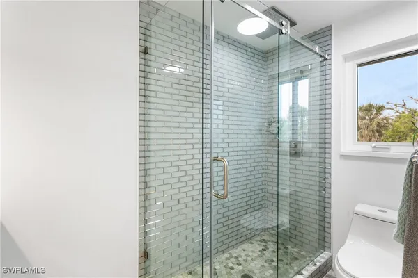 a bathroom with a toilet and shower