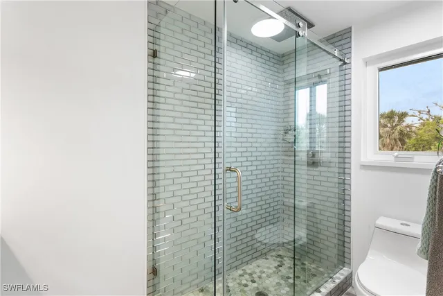 a bathroom with a toilet and shower