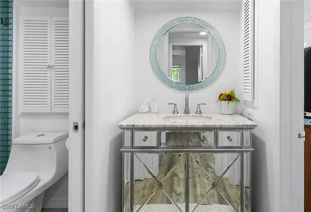 a bedroom with a bed and a night stand