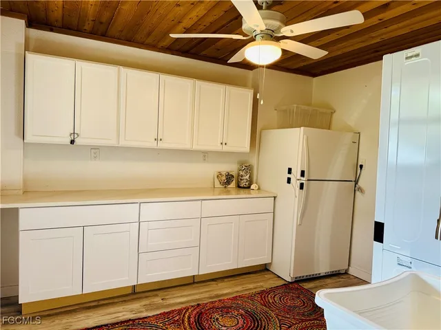 a view of a kitchen with wooden floor