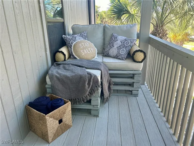 an outdoor sitting area with a table and chairs