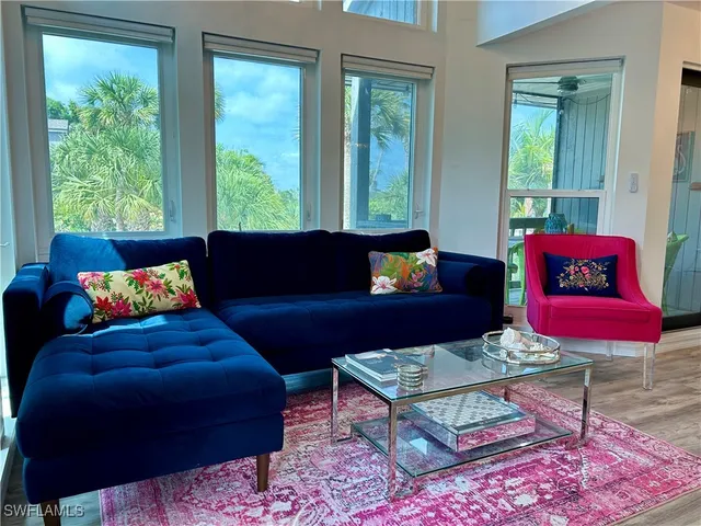 a living room with furniture rug and window