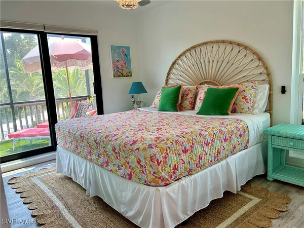 a bedroom with a bed and a large window