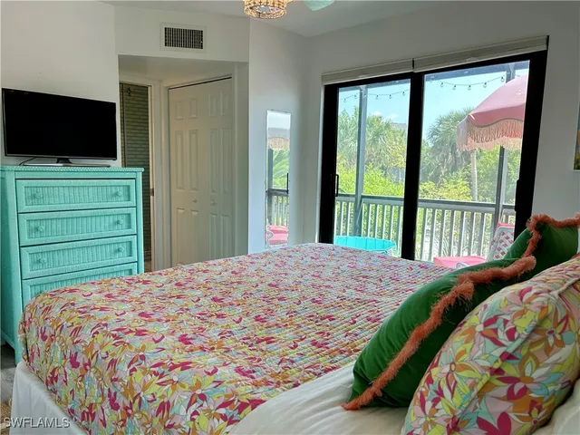 a bedroom with a bed and a television