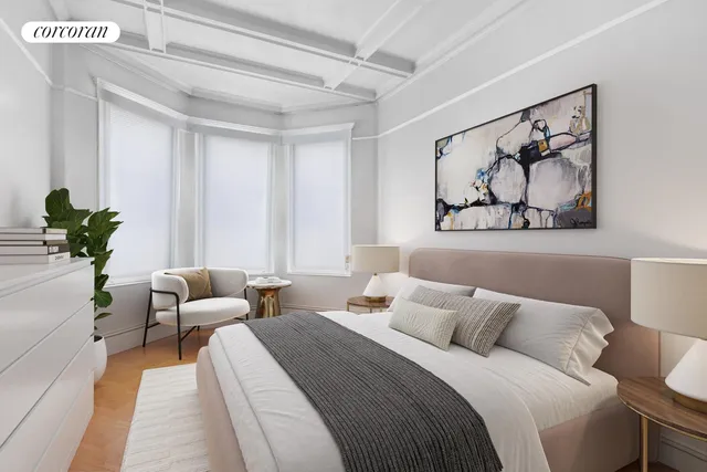 a bedroom with a bed and a painting on the wall