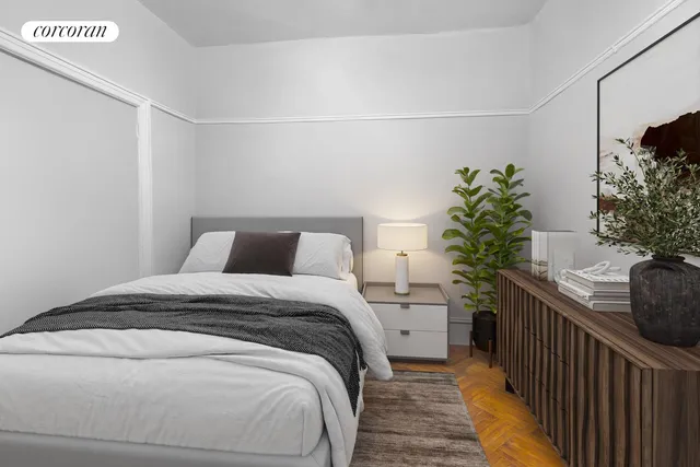 a bedroom with a bed and a potted plant