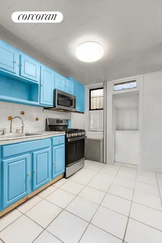 a kitchen with granite countertop a refrigerator and a sink