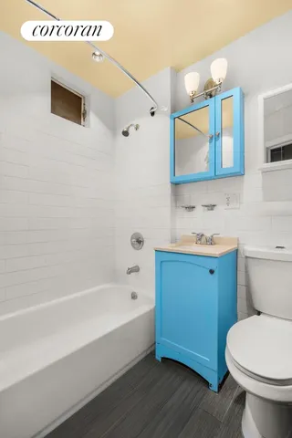 a bathroom with a granite countertop toilet a sink and bathtub