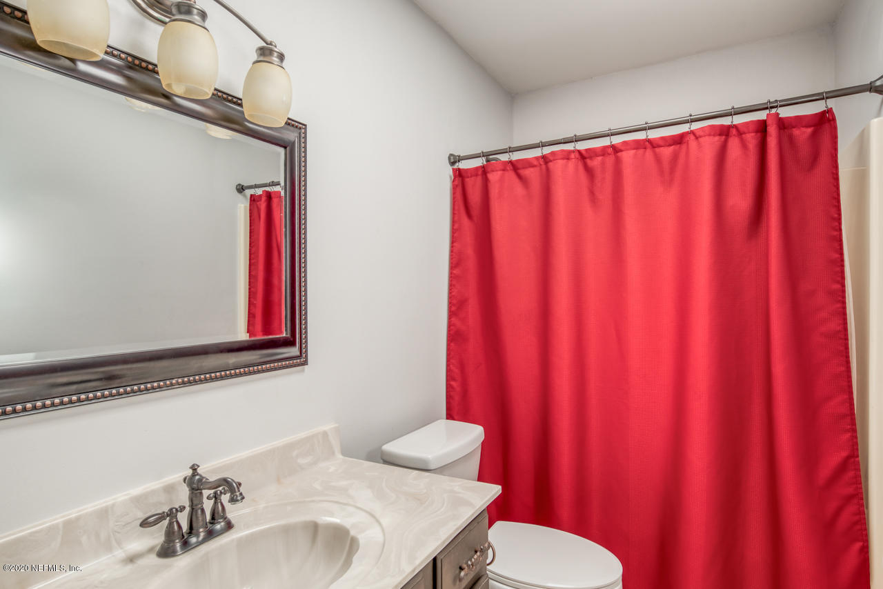 332 Shamrock Road St. Augustine, FL 32086 - Photo 18 of 26 a bathroom with a sink mirror and a toilet