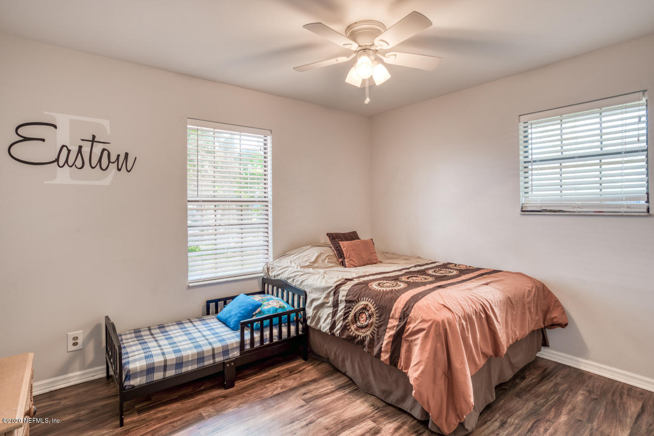 332 Shamrock Road St. Augustine, FL 32086 - Photo 19 of 26 a bedroom with a bed and a chair