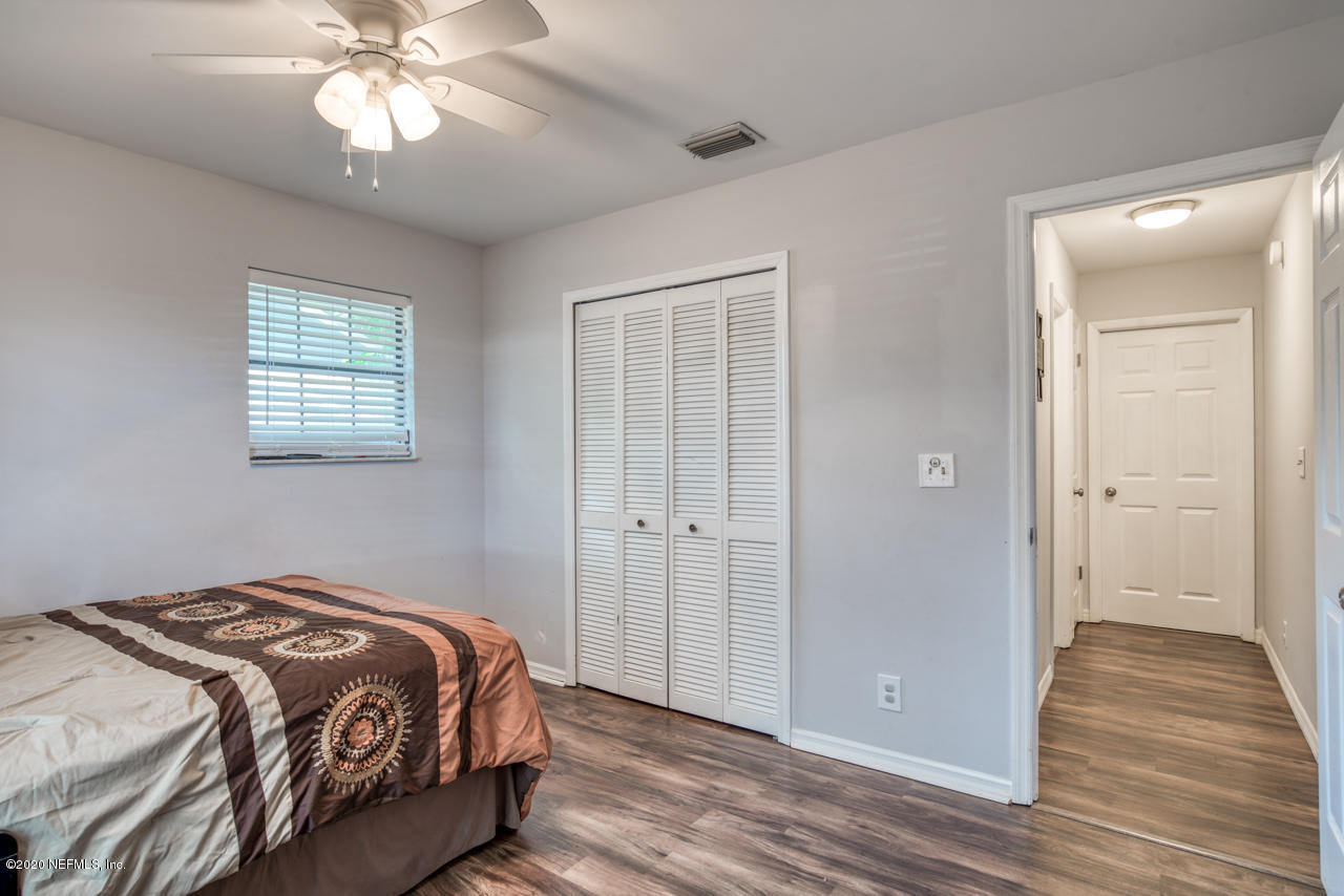 332 Shamrock Road St. Augustine, FL 32086 - Photo 20 of 26 a bedroom with a bed and wooden floor