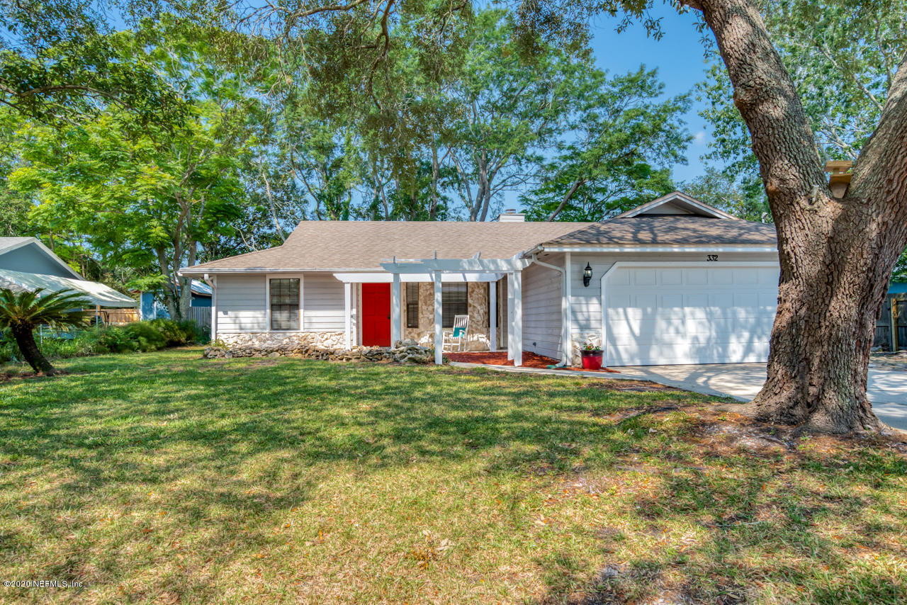 332 Shamrock Road St. Augustine, FL 32086 - Photo 2 of 26 a front view of a house with a garden